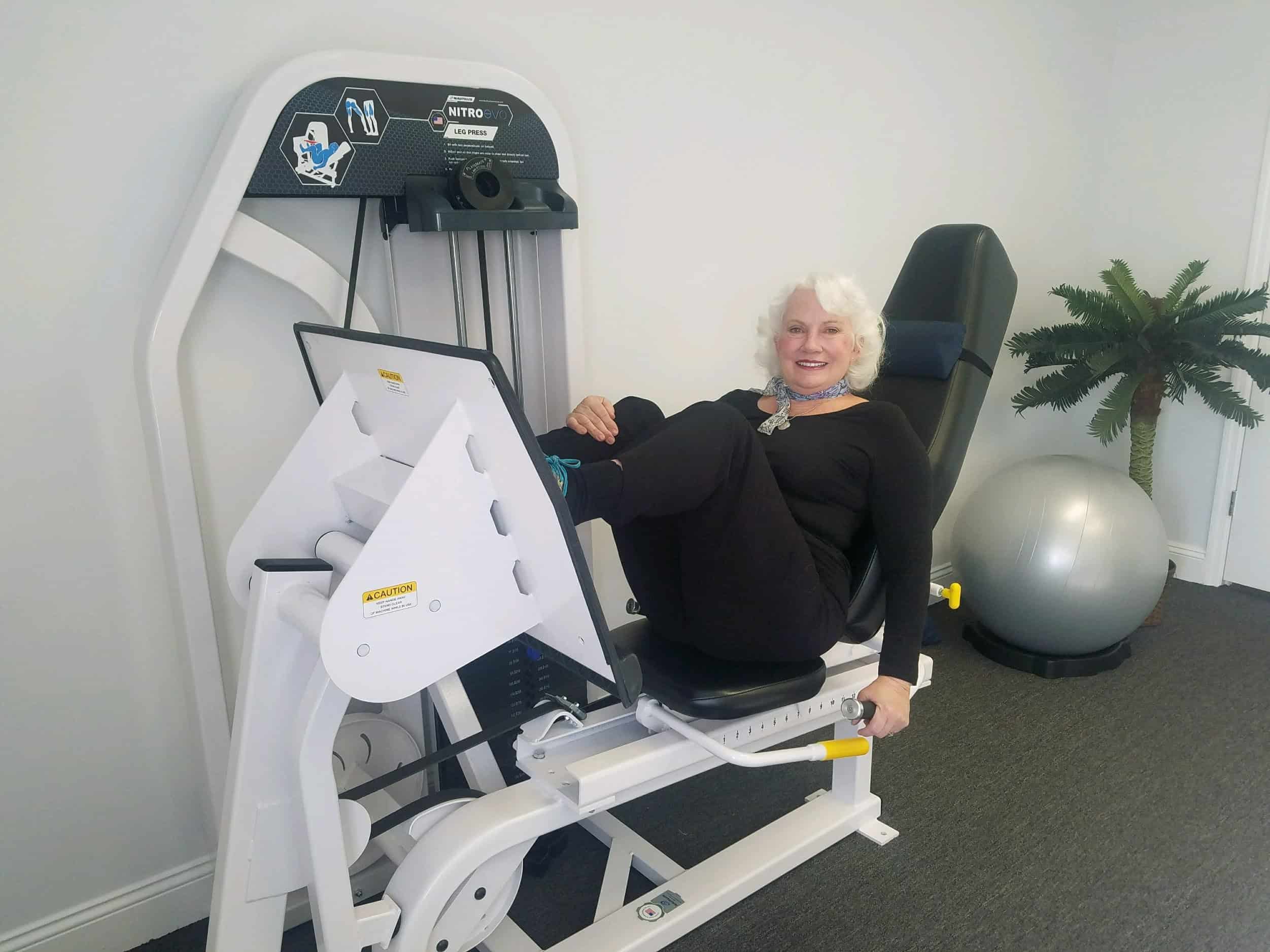 woman using leg press machine to rehab knees