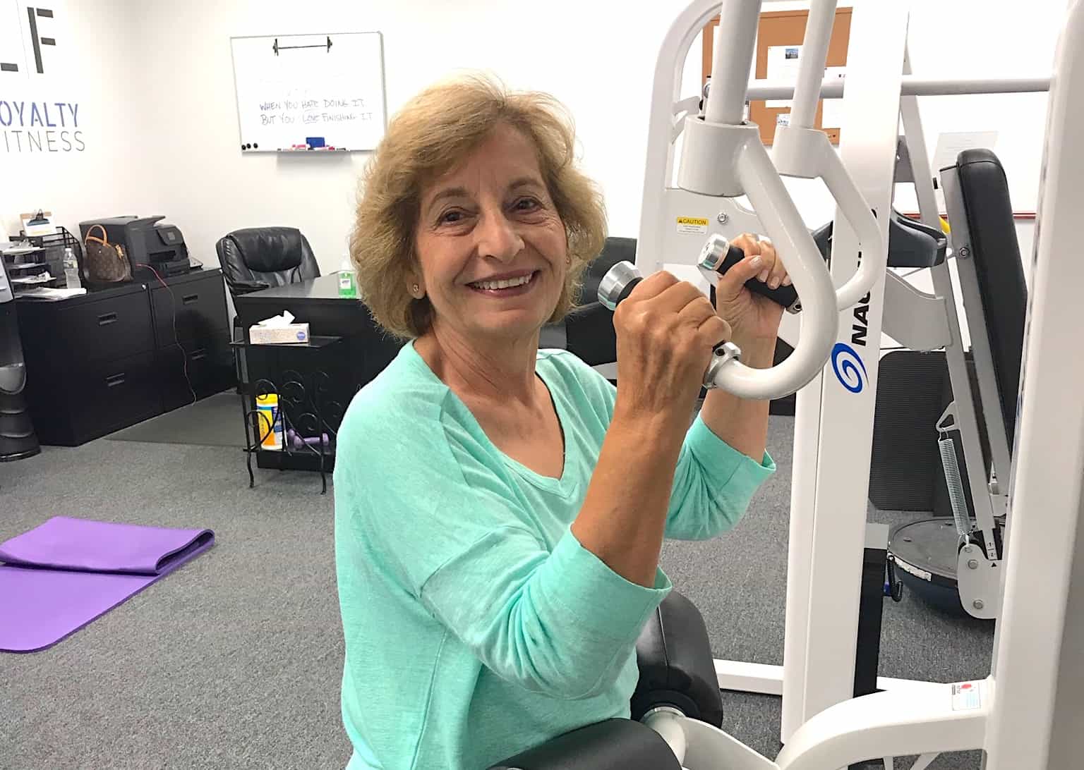 Woman on a workout machine at Loyalty Fitness.