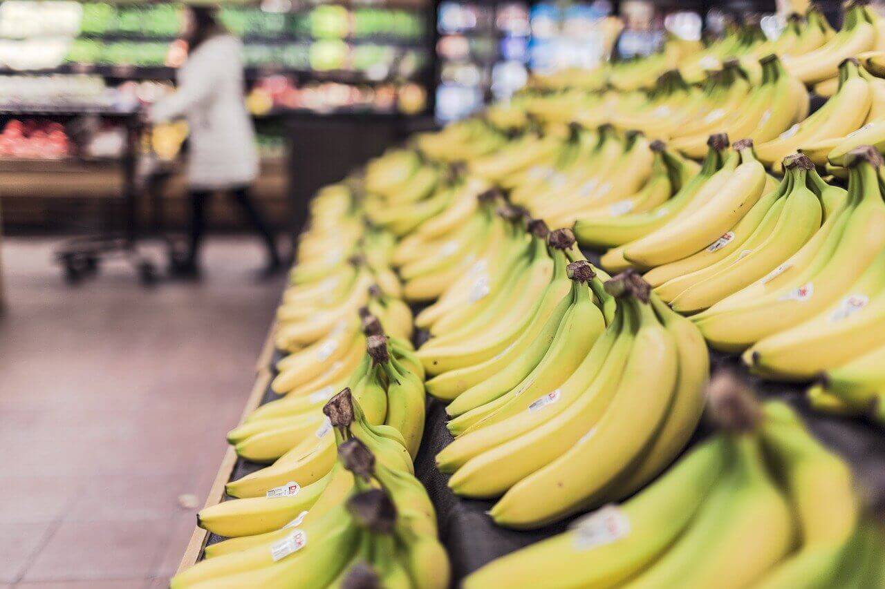 Rack of bananas in a grocery store.