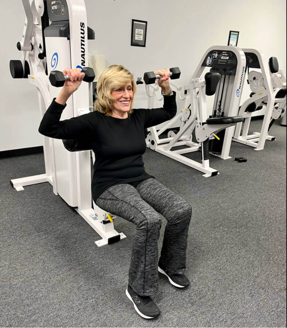 A senior woman strength training at a Loyalty Fitness gym.