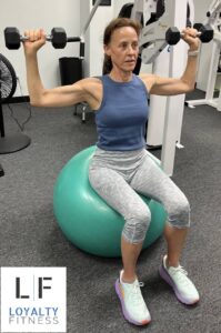 Ellen H. Syosset working out on a ball with free weights