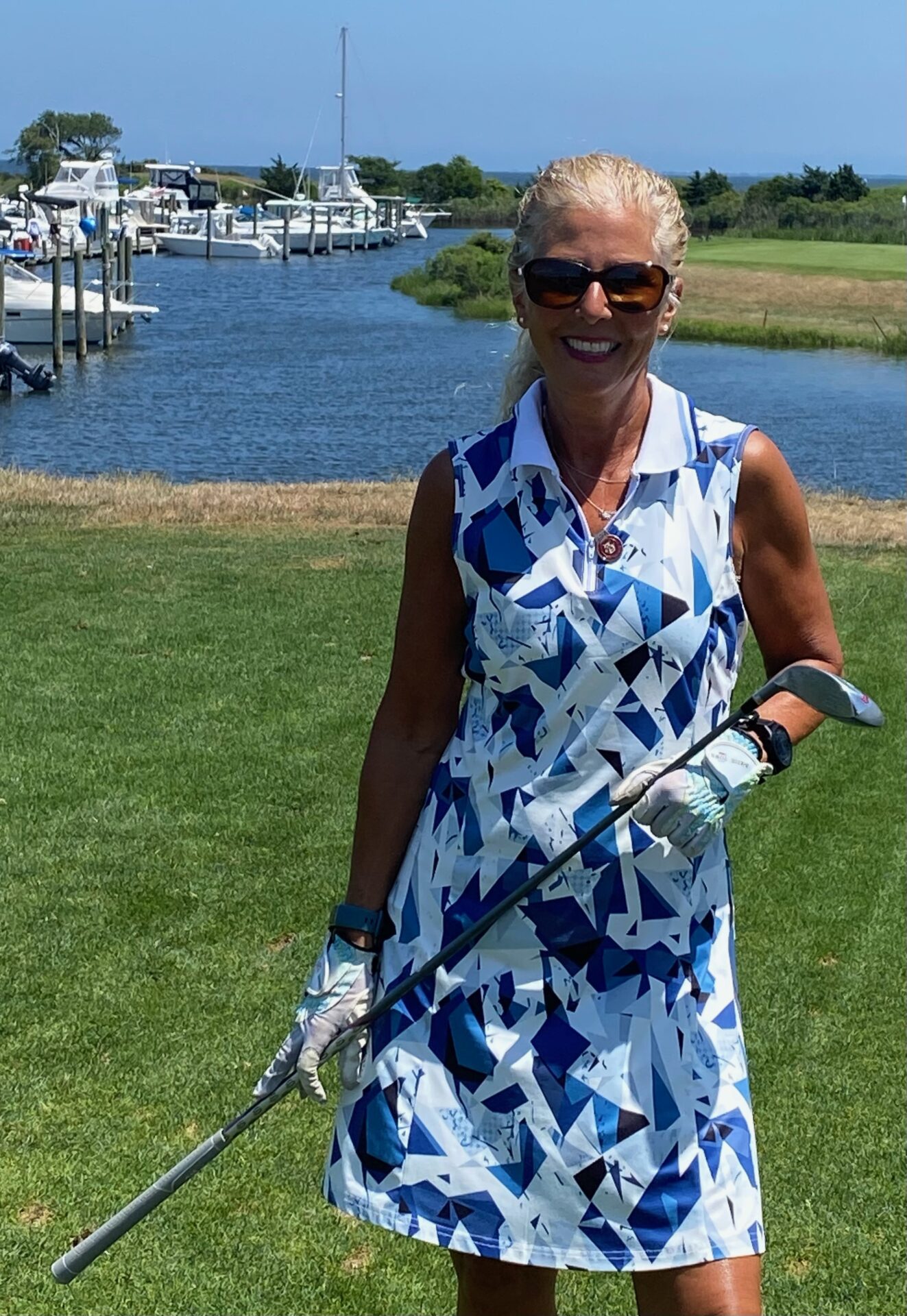 A Loyalty Fitness personal trainer holding a golf stick at a golf course. 